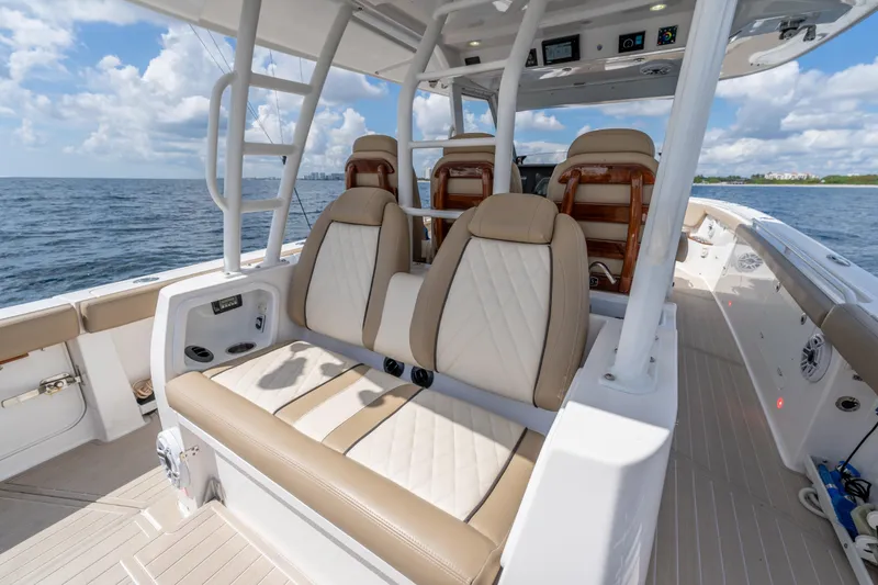 Slide: The Image of 2021 Everglades 395 Center Console boat interior with luxurious seating on open water. - 67