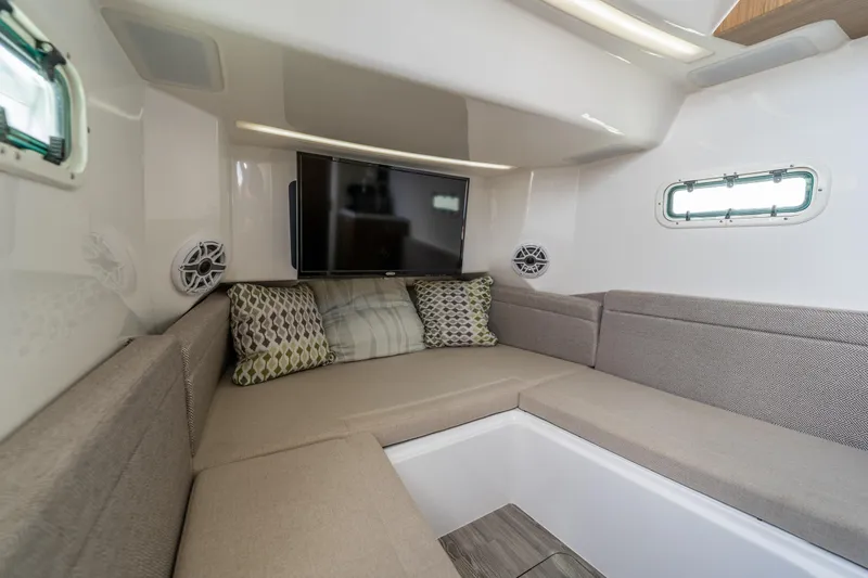 Slide: The Image of Interior of 2021 Everglades 395 Center Console with cozy seating and TV. - 77