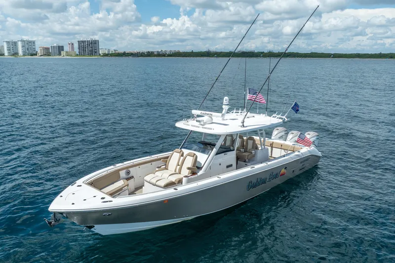 Slide: The Image of 2021 Everglades 395 Center Console boat on open water, with city skyline in background. - 9