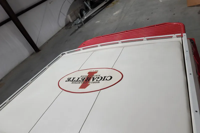 Slide: The Image of 2000 Cigarette 35 Top Gun LE boat in storage, featuring distinctive branding on deck. - 13