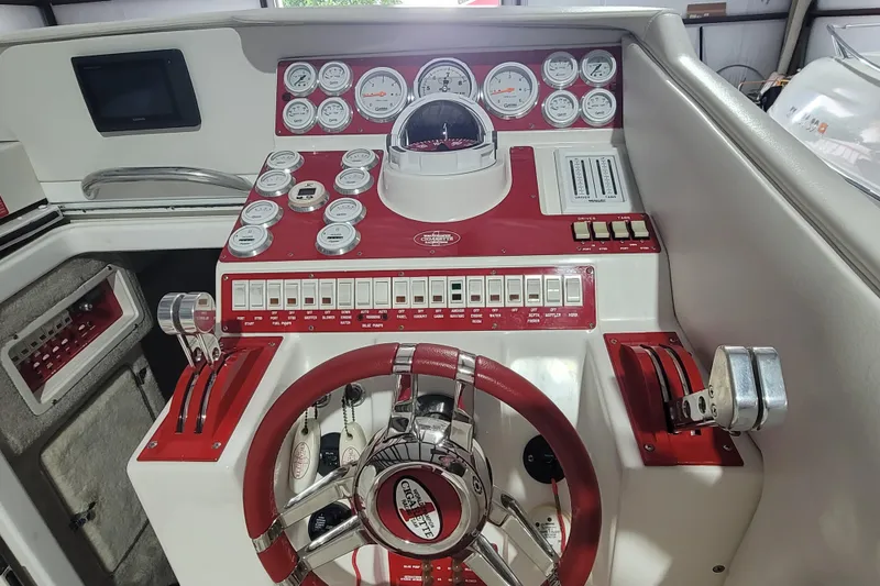 Slide: The Image of Control panel of a 2000 Cigarette 35 Top Gun LE boat with gauges and steering wheel. - 14