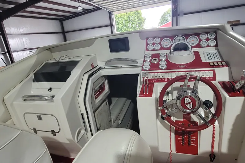 Slide: The Image of 2000 Cigarette 35 Top Gun LE boat cockpit with red and white dashboard and steering wheel. - 15