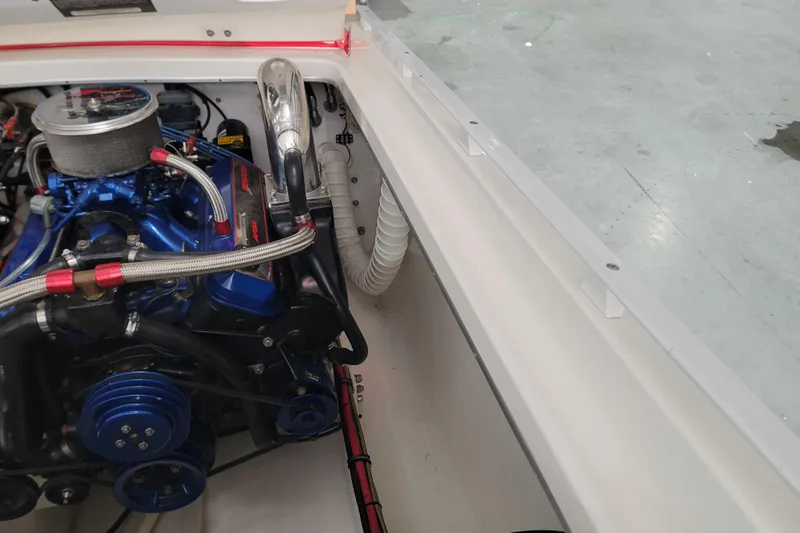 Slide: The Image of Engine compartment of a 2000 Cigarette 35 Top Gun LE boat, showcasing detailed components. - 16