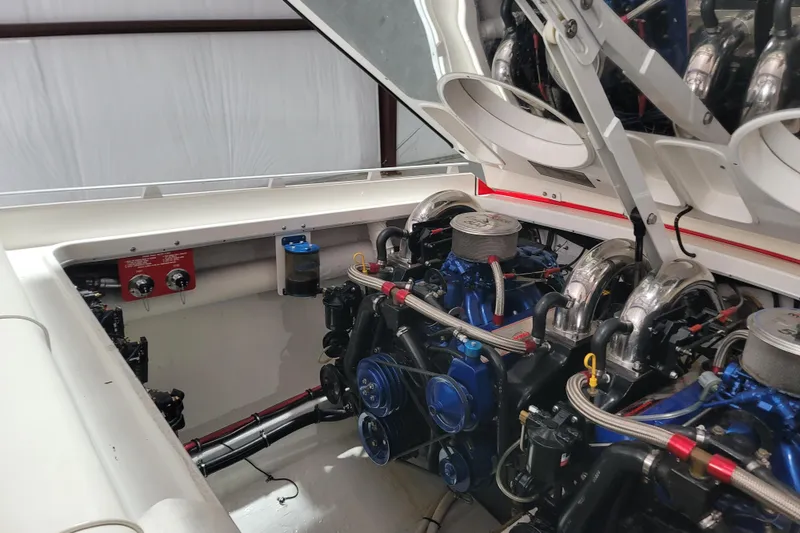 Slide: The Image of Engine compartment of a 2000 Cigarette 35 Top Gun LE boat, showcasing dual engines. - 17