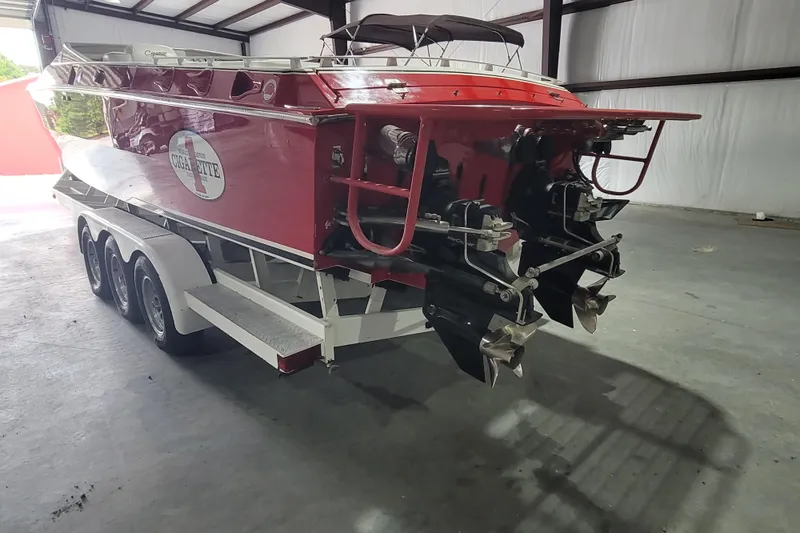 Slide: The Image of Red 2000 Cigarette 35 Top Gun LE boat on trailer in warehouse. - 3