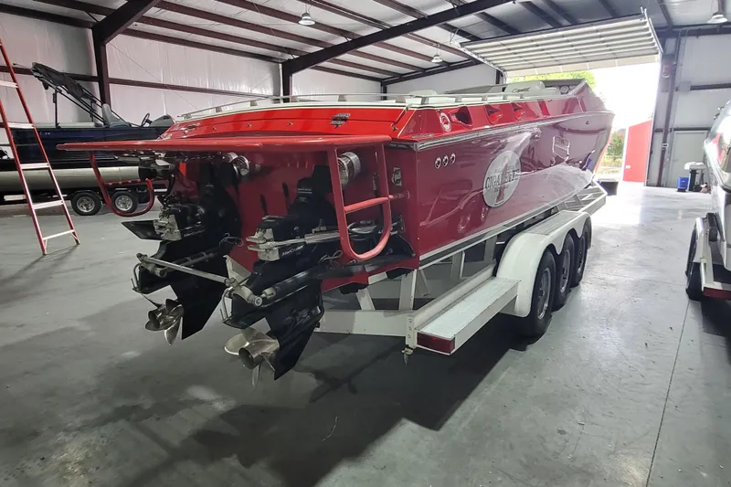 Slide: The Image of Red 2000 Cigarette 35 Top Gun LE boat on trailer in a warehouse. - 5