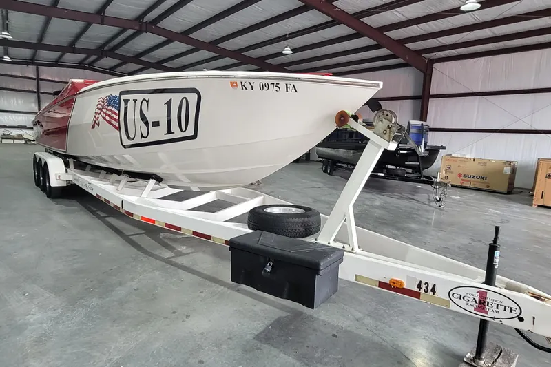 Slide: The Image of 2000 Cigarette 35 Top Gun LE boat on trailer in warehouse setting. - 7