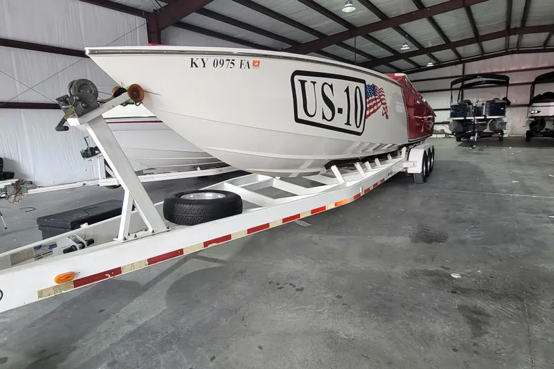 Slide: The Image of 2000 Cigarette 35 Top Gun LE boat on trailer in indoor storage facility. - 9