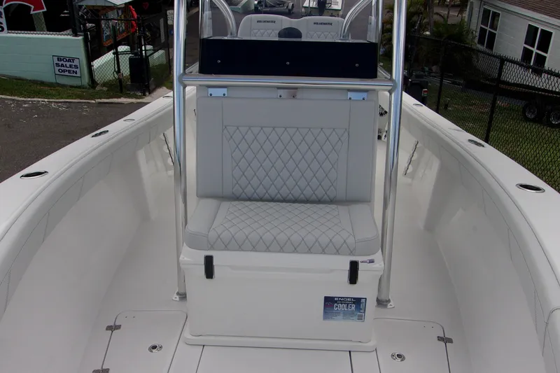 Slide: The Image of 2025 Bluewater 23 T boat interior with cushioned seating and cooler. - 12