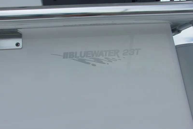 Slide: The Image of 2025 Bluewater 23 T boat logo on sleek white surface. - 18