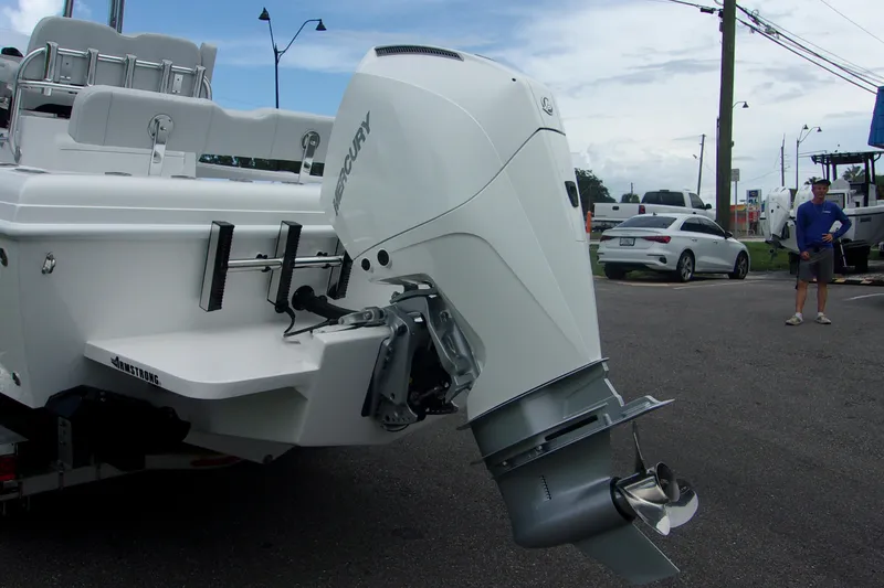 Slide: The Image of 2025 Bluewater 23 T boat with Mercury outboard motor in a parking lot. - 5