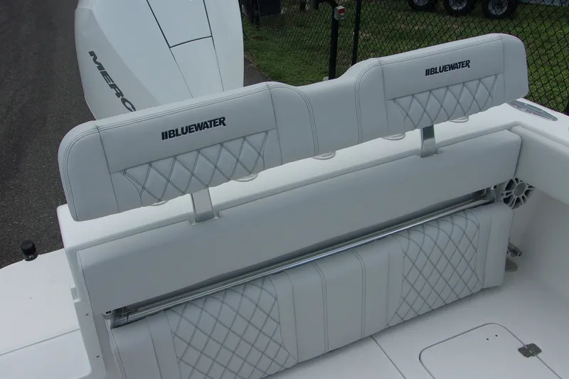 Slide: The Image of 2025 Bluewater 23 T boat with white cushioned seating and diamond stitching. - 6