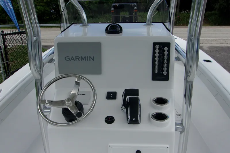 Slide: The Image of 2025 Bluewater 23 T boat console with Garmin navigation and steering wheel. - 9