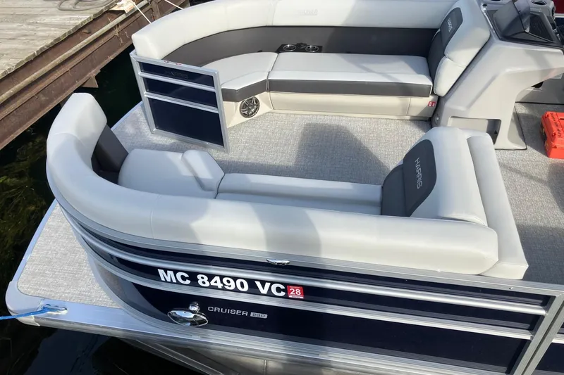 Slide: The Image of 2025 Harris Cruiser 230 pontoon boat interior with plush seating and modern design. - 2