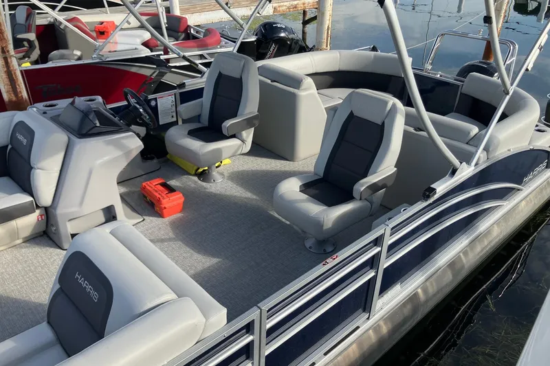 Slide: The Image of 2025 Harris Cruiser 230 pontoon boat with spacious seating and modern design. - 3
