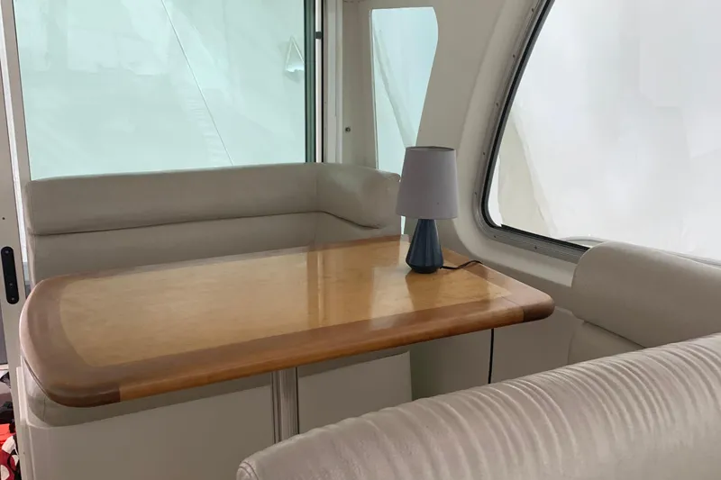 Slide: The Image of Interior of 2008 Back Cove 33 Hard Top Express with wooden table and lamp. - 11