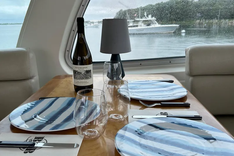 Slide: The Image of Elegant dining setup inside a 2008 Back Cove 33 Hard Top Express yacht. - 13