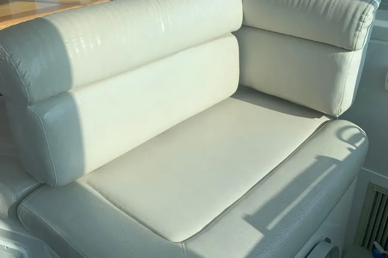 Slide: The Image of White leather seating on a 2008 Back Cove 33 Hard Top Express boat. - 14
