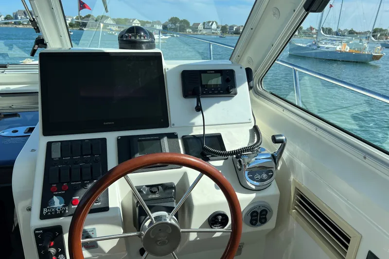 Slide: The Image of 2008 Back Cove 33 Hard Top Express helm with steering wheel and navigation controls. - 20