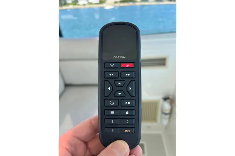Slide: The Image of Hand holding Garmin remote control on a 2008 Back Cove 33 Hard Top Express boat. - 21