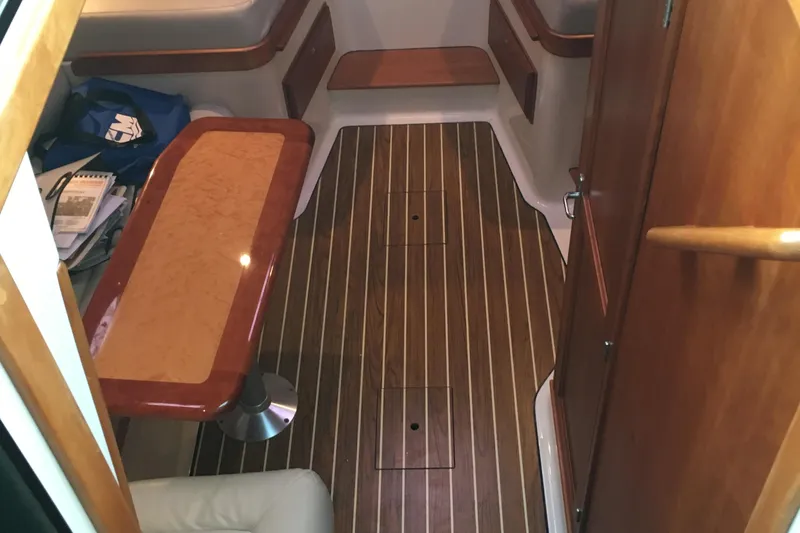 Slide: The Image of Interior of 2008 Back Cove 33 Hard Top Express with wood flooring and table. - 24