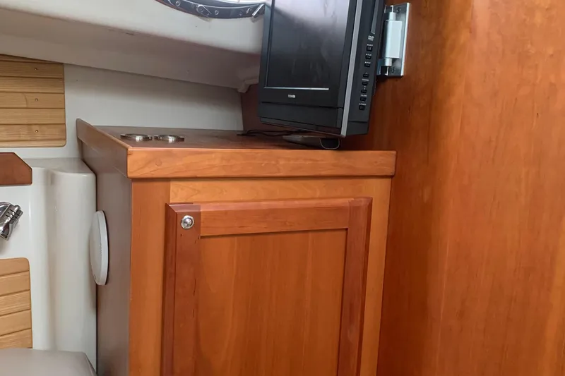 Slide: The Image of Interior of 2008 Back Cove 33 Hard Top Express with wooden cabinetry and mounted TV. - 28