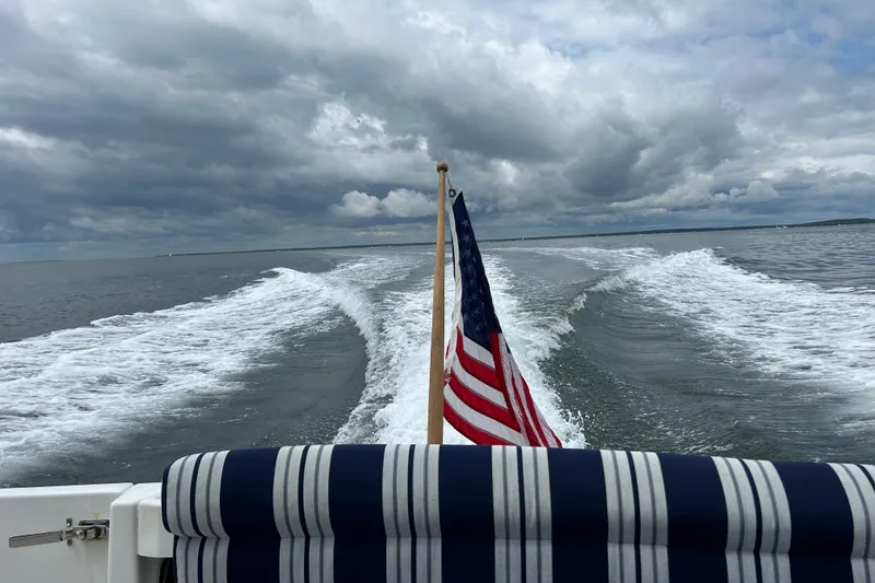 Slide: The Image of 2008 Back Cove 33 Hard Top Express cruising with American flag, under cloudy skies. - 3