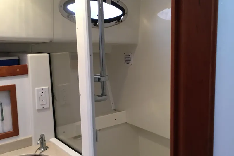 Slide: The Image of 2008 Back Cove 33 Hard Top Express bathroom with sink and shower. - 31