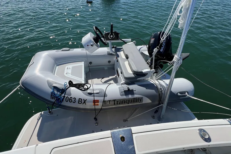 Slide: The Image of Inflatable boat with motor on water, docked to a 2008 Back Cove 33 Hard Top Express. - 40