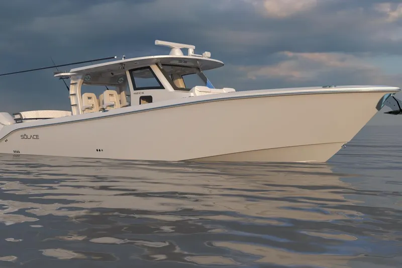 Slide: The Image of 2026 Solace 42 CS boat on calm water under cloudy sky. - 2