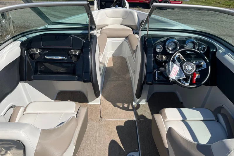 Slide: The Image of Interior view of 2019 Crownline 205 SS boat, featuring steering wheel and seating. - 10