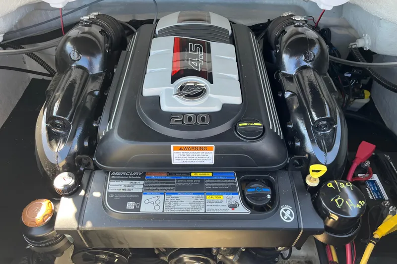 Slide: The Image of 2019 Crownline 205 SS engine compartment featuring a Mercury 4.5L 200 HP engine. - 14