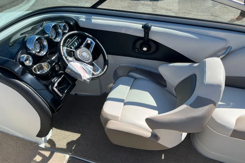 Slide: The Image of 2019 Crownline 205 SS boat interior with steering wheel and dashboard controls. - 16