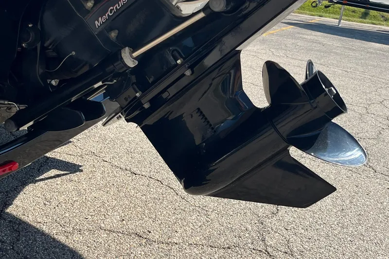 Slide: The Image of 2019 Crownline 205 SS boat propeller and engine detail on pavement. - 17