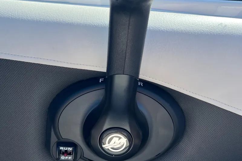 Slide: The Image of Throttle control lever of a 2019 Crownline 205 SS boat, featuring a sleek design. - 19
