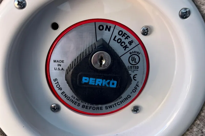Slide: The Image of Perko marine battery switch on 2019 Crownline 205 SS boat, labeled "Off & Lock." - 5