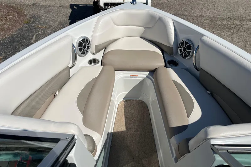 Slide: The Image of 2019 Crownline 205 SS boat interior with cushioned seating and built-in speakers. - 7