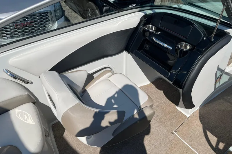 Slide: The Image of 2019 Crownline 205 SS boat interior with seating and dashboard details. - 8