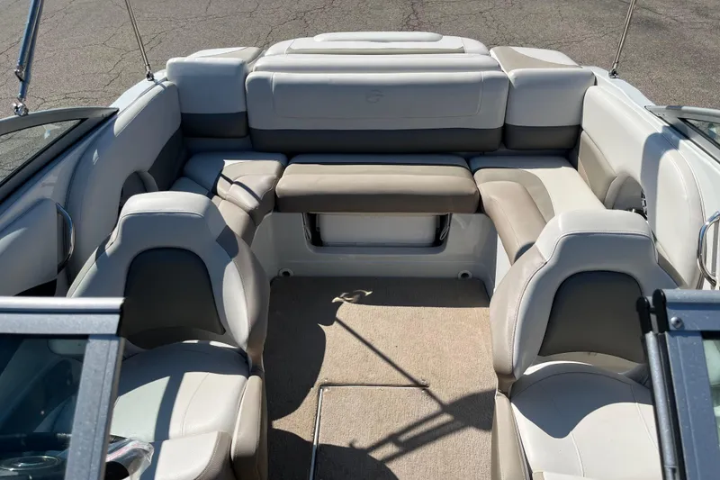Slide: The Image of 2019 Crownline 205 SS boat interior with beige and gray seating arrangement. - 9