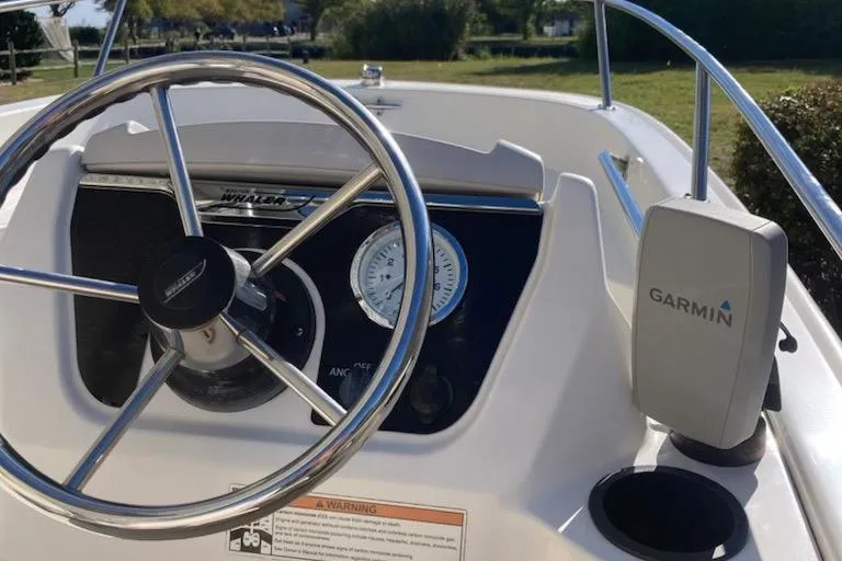 Slide: The Image of Steering wheel and dashboard of 2019 Boston Whaler 130 Super Sport with Garmin device. - 10