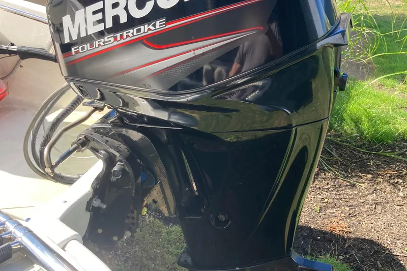 Slide: The Image of 2019 Boston Whaler 130 Super Sport with Mercury FourStroke engine, outdoor setting. - 11