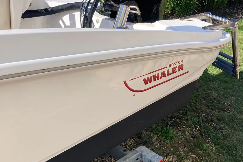 Slide: The Image of 2019 Boston Whaler 130 Super Sport boat, side view with logo visible. - 7