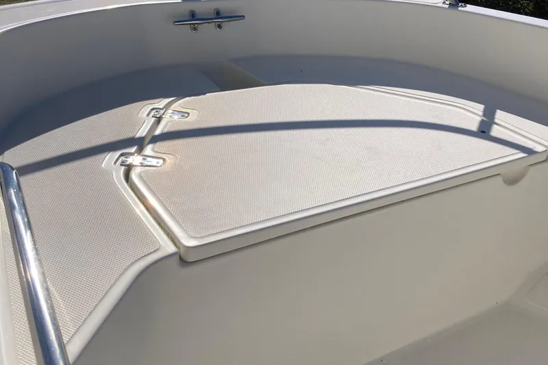 Slide: The Image of 2019 Boston Whaler 130 Super Sport boat deck with stainless steel railing. - 8