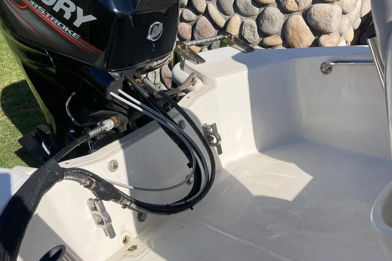 Slide: The Image of 2019 Boston Whaler 130 Super Sport boat engine and interior detail. - 9