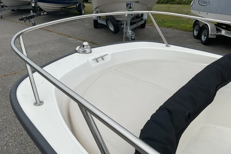 Slide: The Image of 2024 Boston Whaler 150 Montauk boat interior with seating and console details. - 10