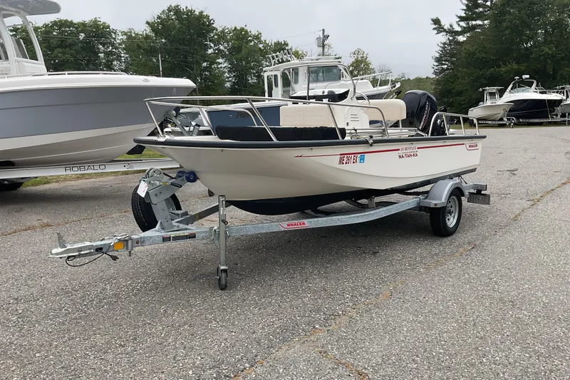 Slide: The Image of 2024 Boston Whaler 150 Montauk boat on trailer in outdoor setting. - 3