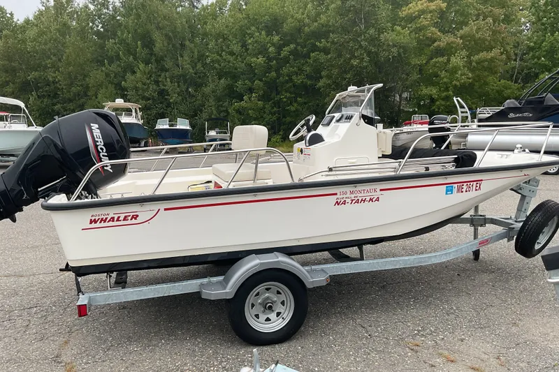 Slide: The Image of 2024 Boston Whaler 150 Montauk boat console with steering wheel and controls. - 8