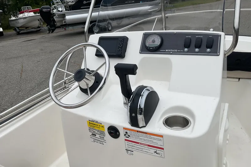 Slide: The Image of 2024 Boston Whaler 150 Montauk boat bow with stainless steel railing and cleat. - 9