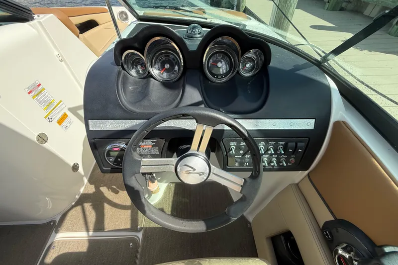 Slide: The Image of 2014 Sea Ray 260 Sundeck dashboard with steering wheel and instrument panel. - 10