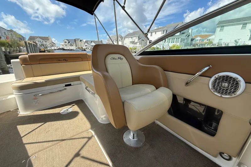 Slide: The Image of 2014 Sea Ray 260 Sundeck interior with tan seating and waterfront view. - 12